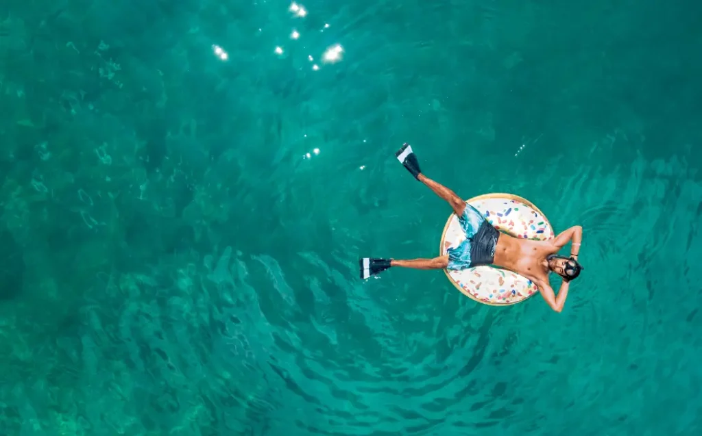 A person relaxing in a pool.
