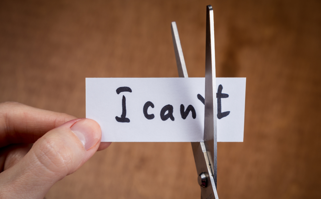 Scissors cutting negative label, self motivation concept