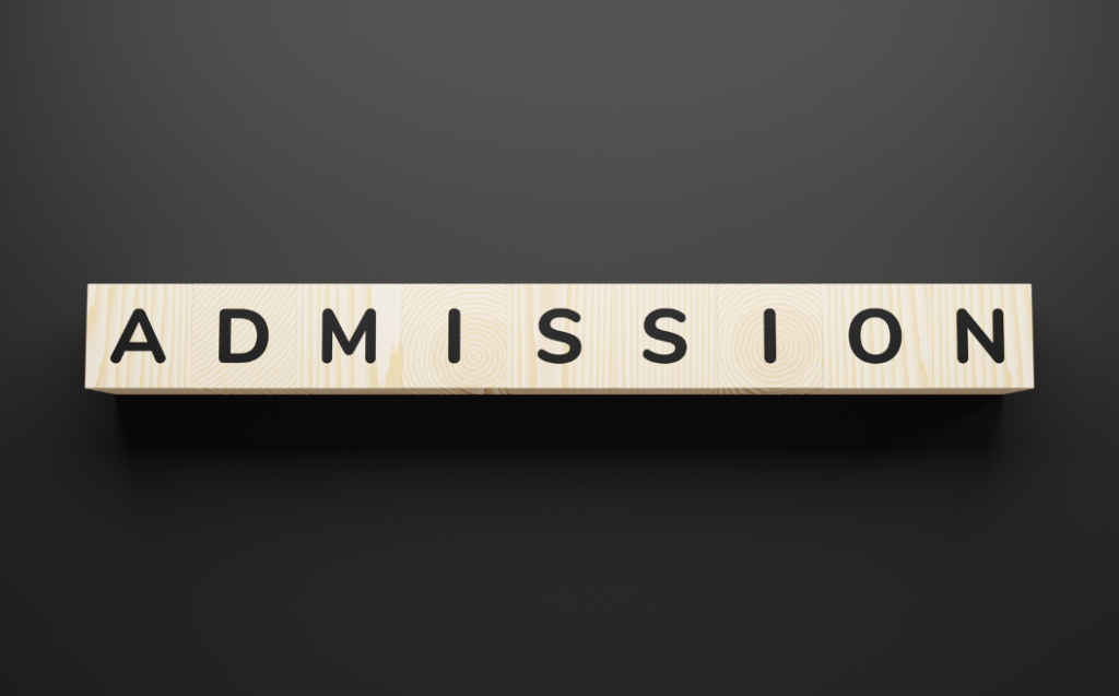 Word admission on wooden blocks.