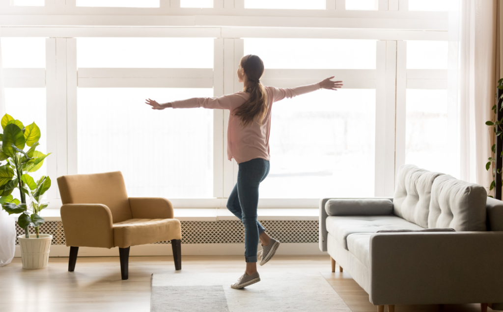 Happy active woman dancing alone.