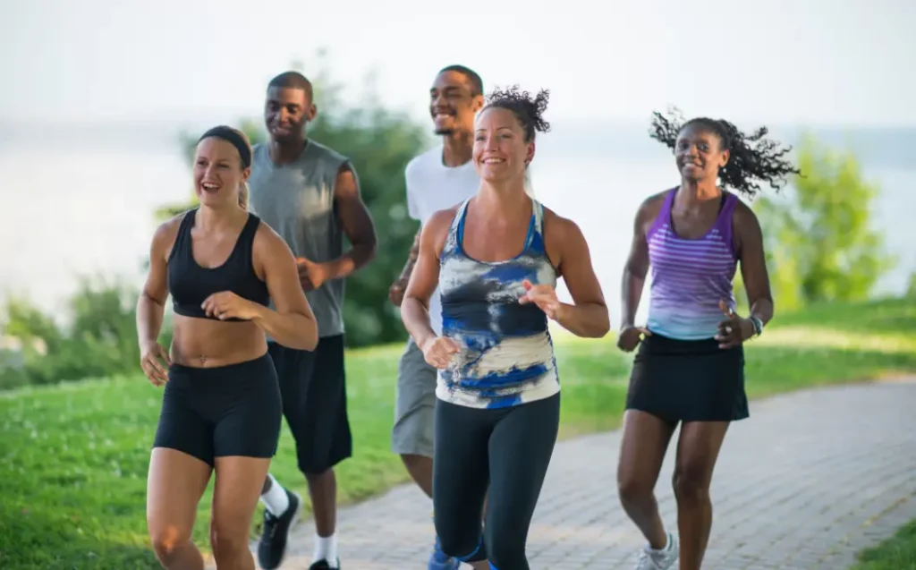 group of adults running outside